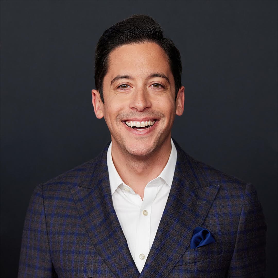 Michael Knowles smiling in a dark suit