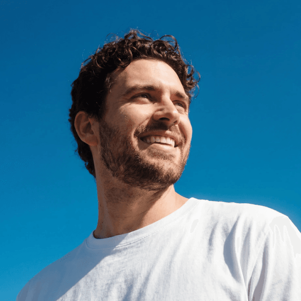 A smiling man in a white t-shirt