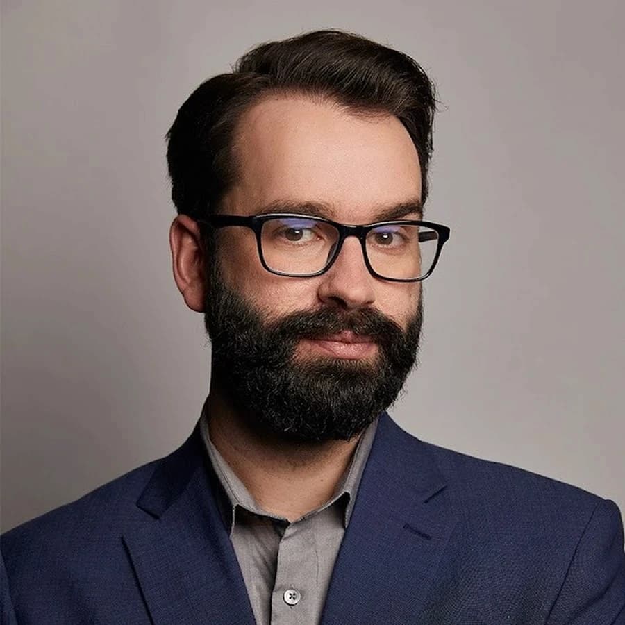 Matt Walsh in glasses and a navy blazer